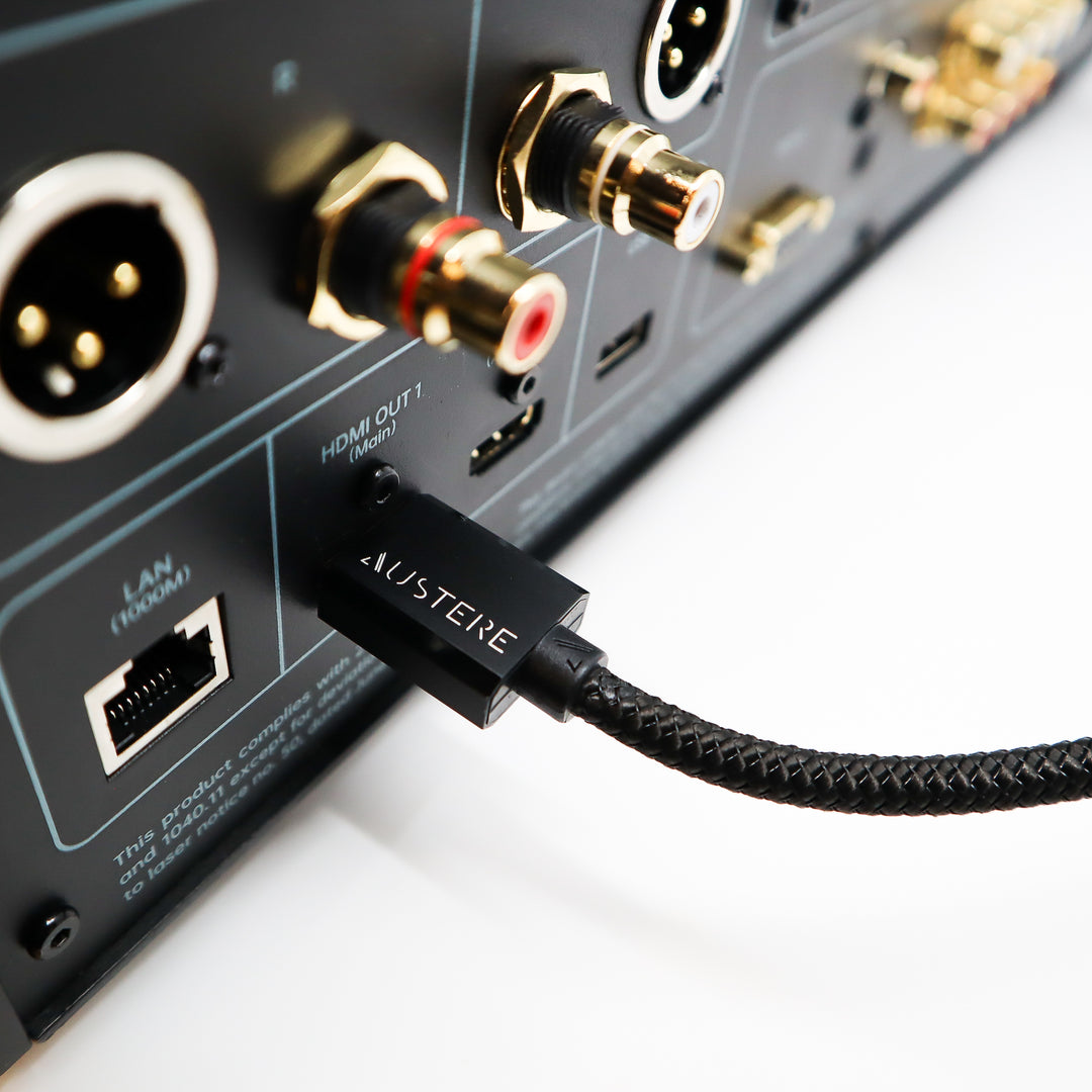 Audio interface with a cable labeled 'Austere' plugged into it on a white background