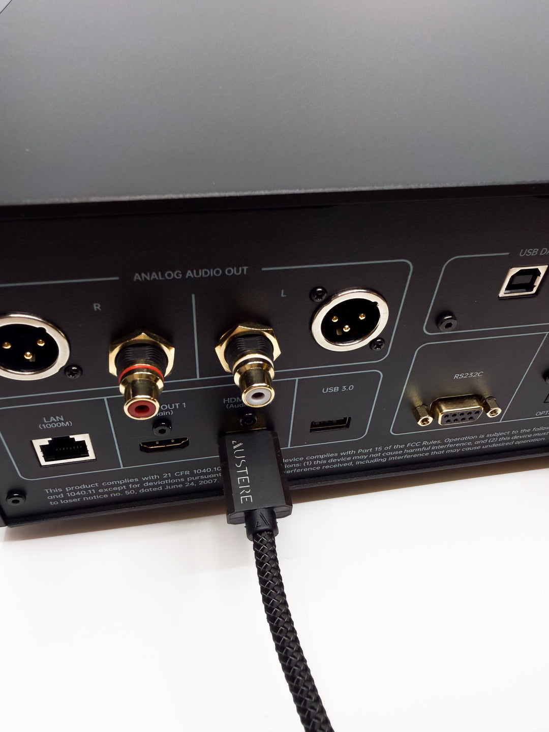 Audio equipment with a cable plugged into a port labeled 'Analog Audio Out'.