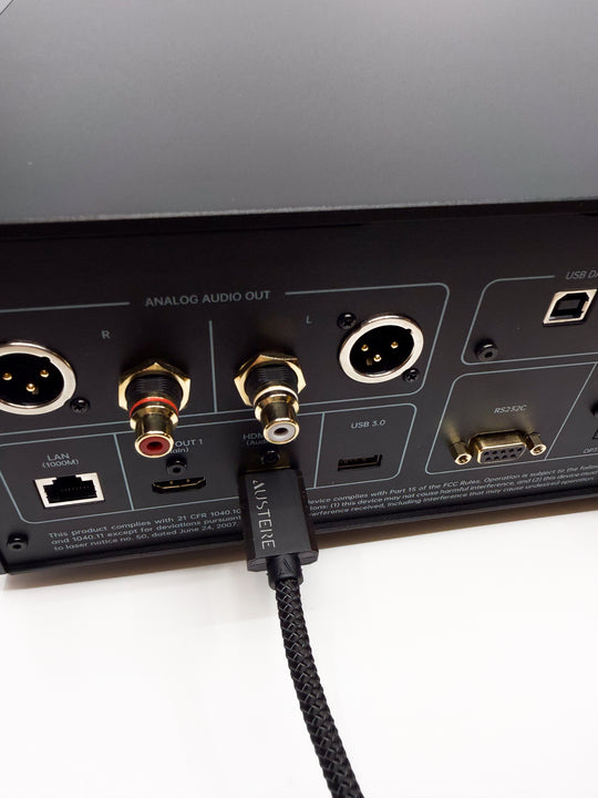 Audio equipment with a cable plugged into a port labeled 'Analog Audio Out'.